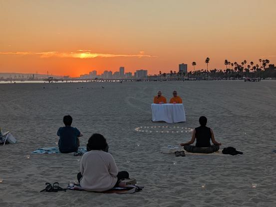 Meditators at sunset at longbeach on August 23rd 2025