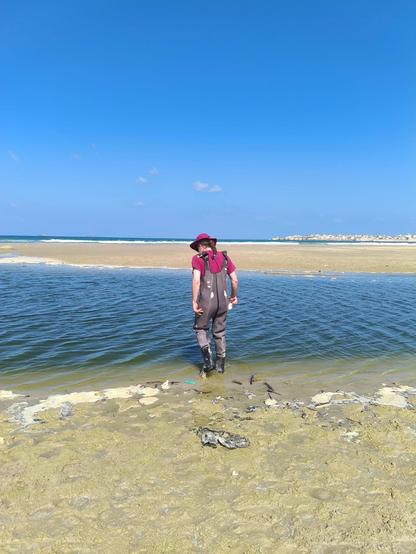 Trepidatiously going into the water, hoping that the waders won't leak.
