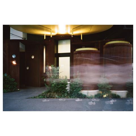 The toilet building has a rusty surface, with a round golden ceiling illuminated by a light.
