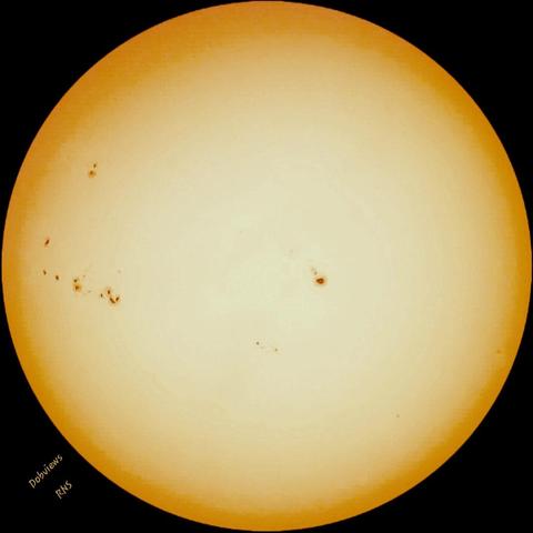 A view of our Sun today taken with a white light filter and a 40 mm lens. Just left of center is a large sunspot and dotted across the Western Limb (left side) is a line of very active synspots. In the center the sun takes on the hue of a very light yellow and around the edges fades to a burnt orange.