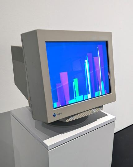 A retro Eizo CRT computer monitor on a white pedestal, displaying abstract colorful bar-like shapes in shades of blue, pink, purple, and green. The monitor is gray with a thick frame and is presented in a minimalist gallery setting with a plain white wall behind it.