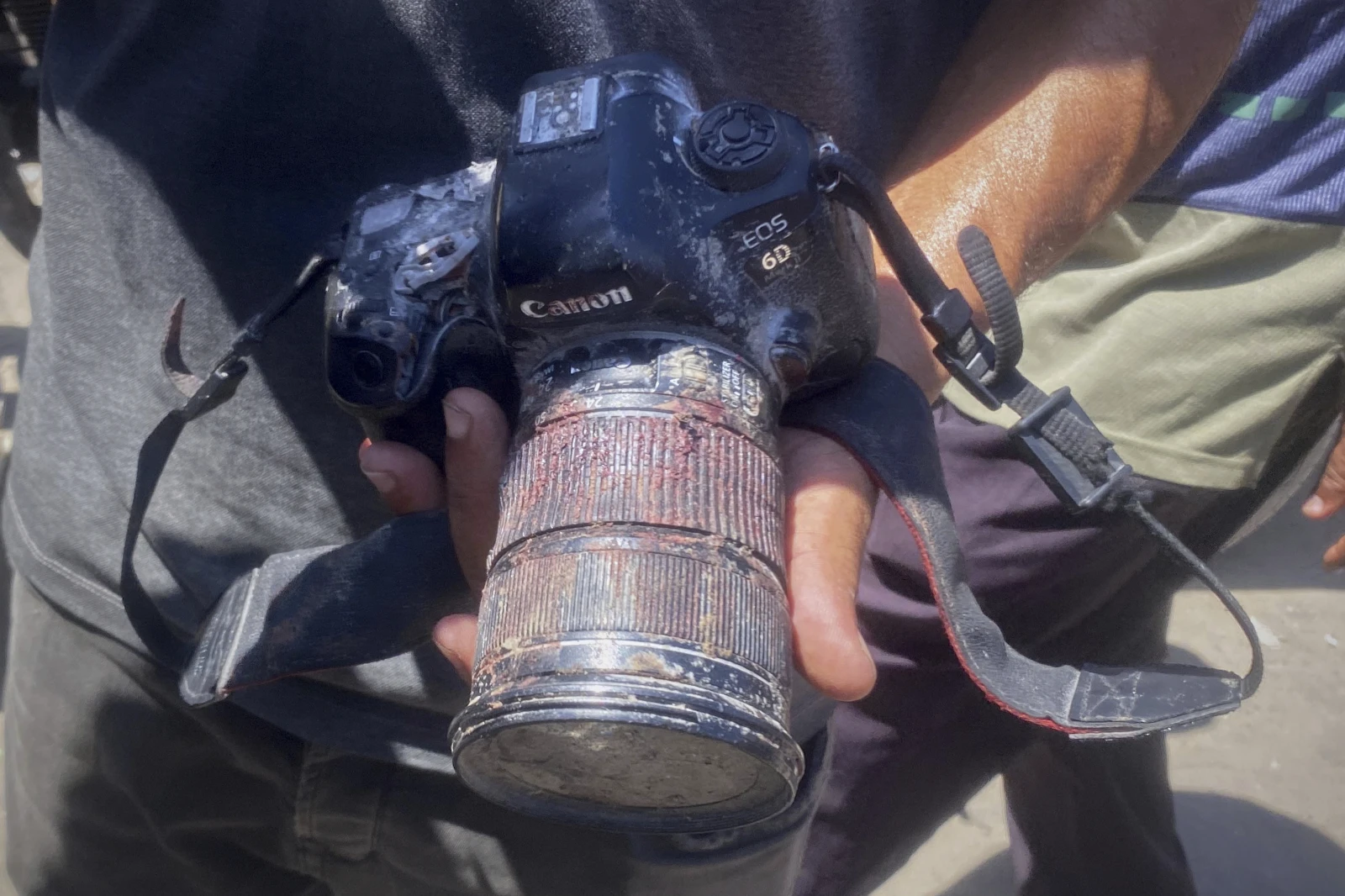 In this family handout photo, a person shows the blood-stained camera that freelance journalist Mariam Dagga, 33, was carrying when she was killed in a double Israeli strike on Nasser Hospital in Khan Younis, southern Gaza Strip, Monday, Aug. 25, 2025. (Family Handout via AP)