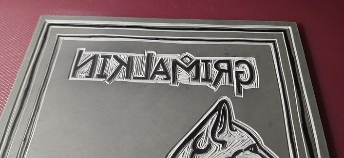 Image 2 of 3: A closeup of the text "Grimalkin" carved into lino.