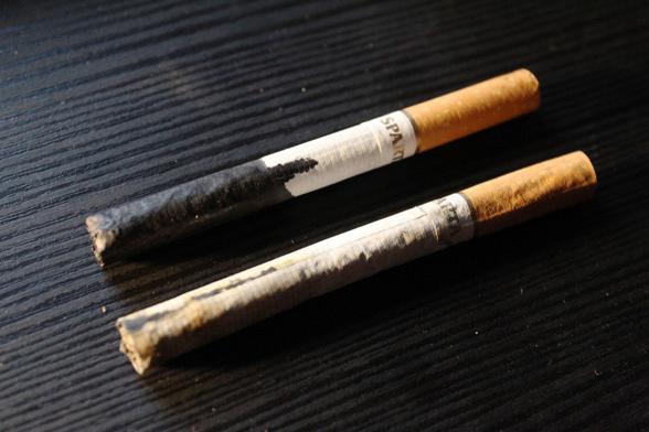 the last two cigarettes on earth, one dipped in ink, the other in rubbing alcohol and turpentine