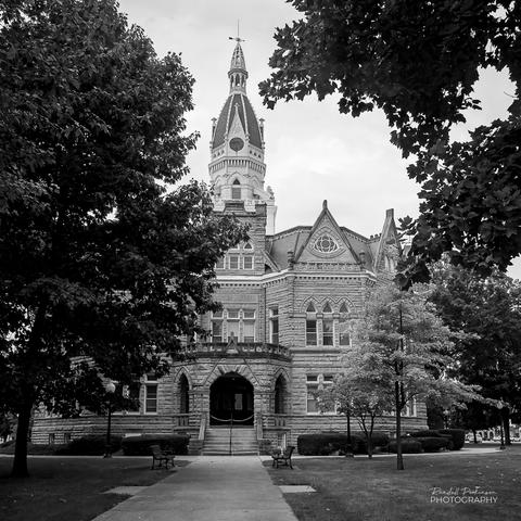A photo of a large county courthouse constructed of stone with a central tower.