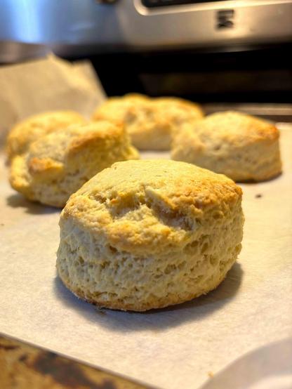 A round scone on the cookie tray.. Lumpy (because of how I shape them) and really good lift.