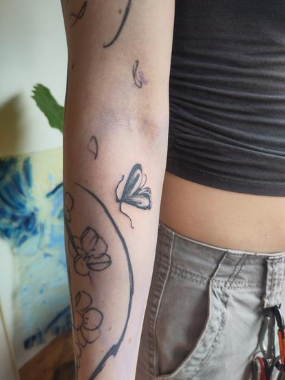 Little moth tattoo on an arm