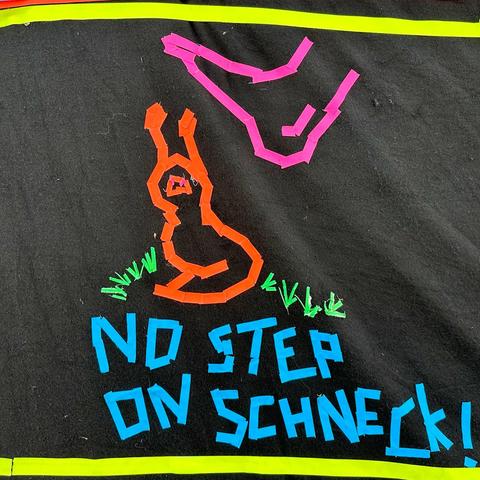 "no step on schneck" sign on UV wall