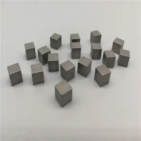 a handful of tungsten cubes scattered across an off-white surface