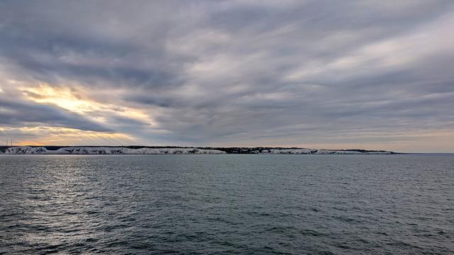 View from the ferry to the white cliffs of dover at sunset.