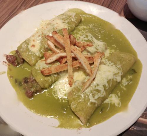 green mexican enchiladas filled with chicharrón, cheese and chicken breast.