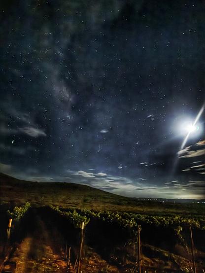 Photo from Sonoita night skies and winery illuminated by the partial moon.  Stars peak through some floaty clouds under the hdr scenery
