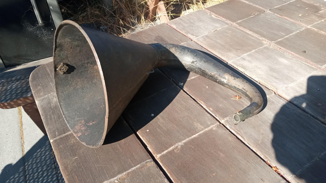 Edison Amberola horn.  It's black and sort of J-shaped.  If you can imagine the lower half of a J expanding into a cone.