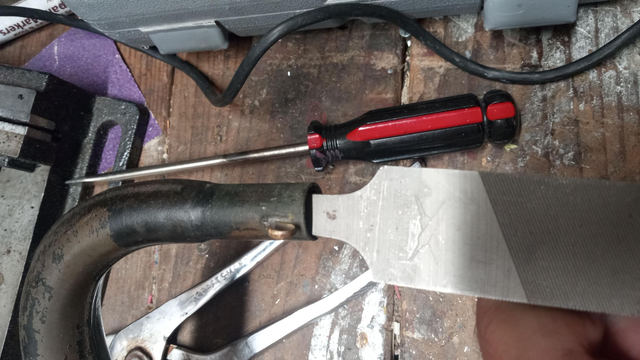 twisting the handle of a big file inside the tube to try to force out more of the crappy old pot metal.