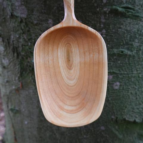 Closeup of the bowl of a wooden spoon.