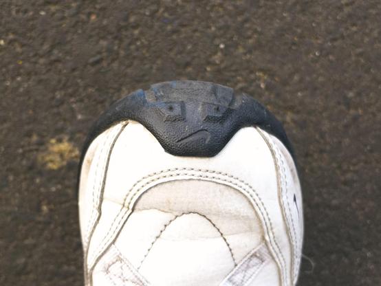 An upside-down Nike logo and two bumps on the toe of my trainers resemble an unhappy face.