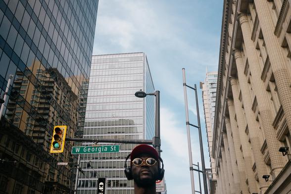 A man with headphones and sunglasses navigates down the centre of Granville.