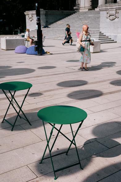 Pedestrians navigate through a field of polka dots.