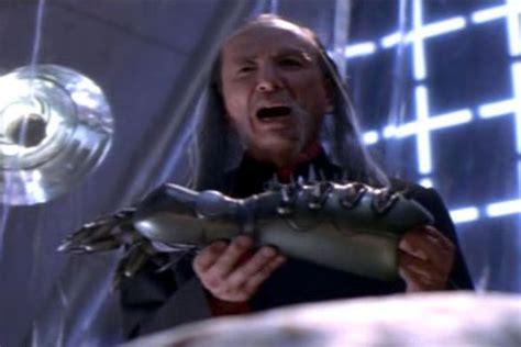Screenshot from the movie 'Tank Girl' - James Hong holding a robotic prosthetic arm