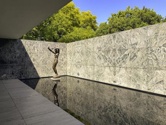 Photo of sculpture in pool in modernist building