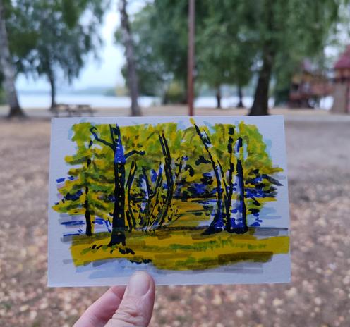 Croquis aux feutres d'un crépuscule sur le Lac de Vassivière, entre les bouleaux et les frênes. Photographié devant le paysage en question.