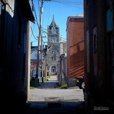Looking down an alley on a bright sunny morning toward the large Marion County Courthouse in Palmyra, Missouri, USA