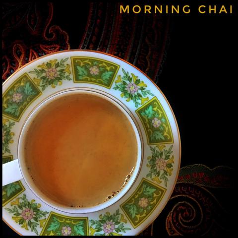 A cup of beautiful morning chai in a green patterned tea cup.