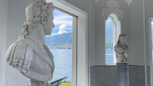 Monti's bust of Ferdinand I gazed over to Tadini's bust of Josephine Barbo. In the background is the water of lake Como and mountains in the distance. Both busts are white, as is the interior of the pavilion in which they are situated