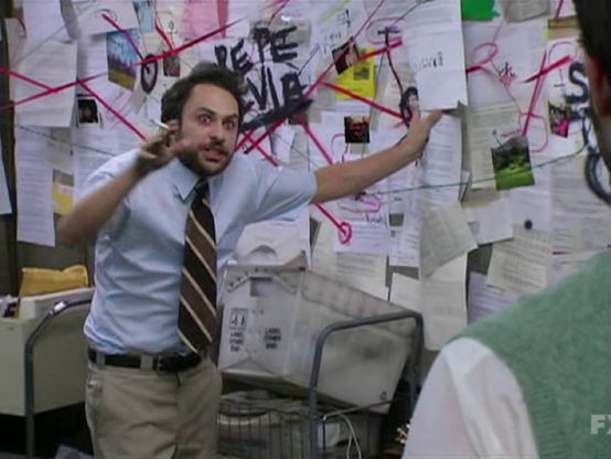 Meme with an agitated, bearded person with a tie in front of a wall of papers with red criss-crossing lines and big, supposedly explaining something to someone else. (Charlie Conspiracy (Always Sunny in Philidelphia)?)