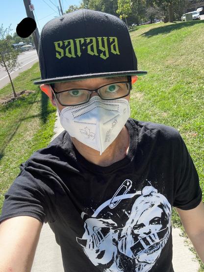 Me wearing a Saraya hat and a Ruby Riott / Liv Morgan shirt, while wearing a white CAN95 mask.
