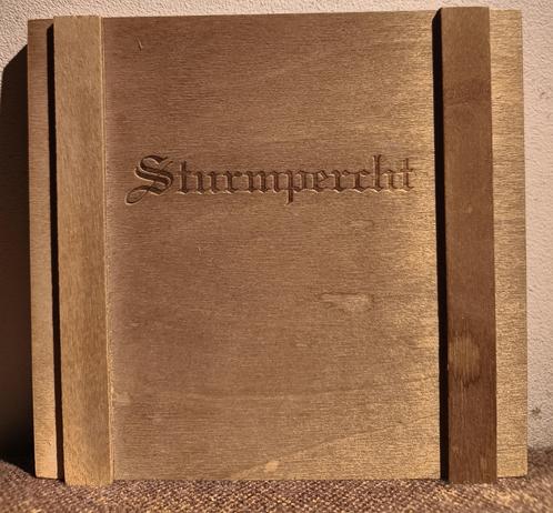 Wooden cover with "Sturmpercht" carved.
