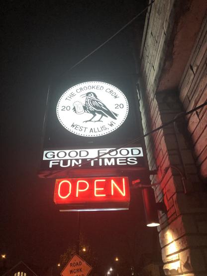 The Crooked Crow “good food. Fun times” sign outside bar 

Established 2020. A crow holding a mug of beer.