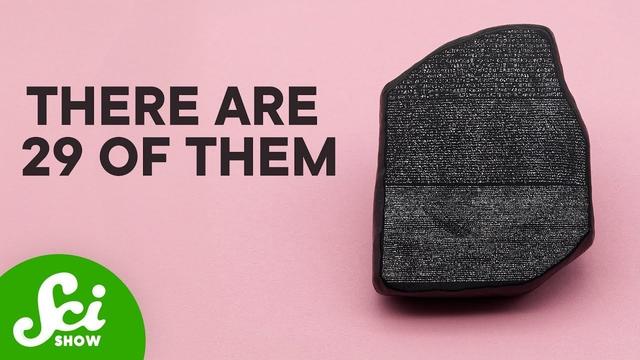 A dark granite stone fragment with three distinct sections of ancient text carved into its surface, displayed against a pink background with "THERE ARE 29 OF THEM" in large black letters and the SciShow logo in the bottom left corner.