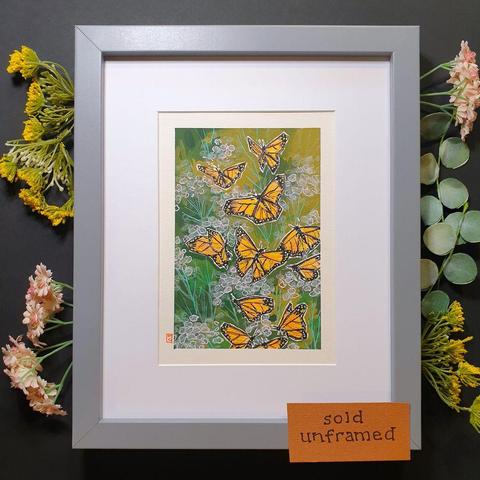A small drawing of a group of orange and black monarch butterflies in flight with a green background with abstract flowers. The drawing is on white paper.
The name monarch is believed to have been given in honour of King William III of England, as the butterfly's main colour is that of the king's secondary title, Prince of Orange.
An original art work
Colour pencil and mixed media on acid free toned artist paper
5 by 7 inches (12.7 by 17.8 cm).
Sold unframed