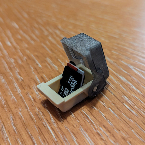 A 3D print of a old styled diskette case but so small it can fit microSD cards.