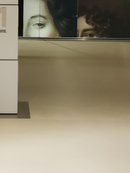 Close-up view of art exhibit featuring classical portraits