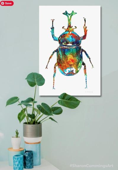 Colorful beetle art on crisp white in a decor setting by artist Sharon Cummings.