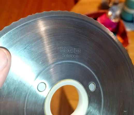 The rotary knife, serrated for cutting bread.