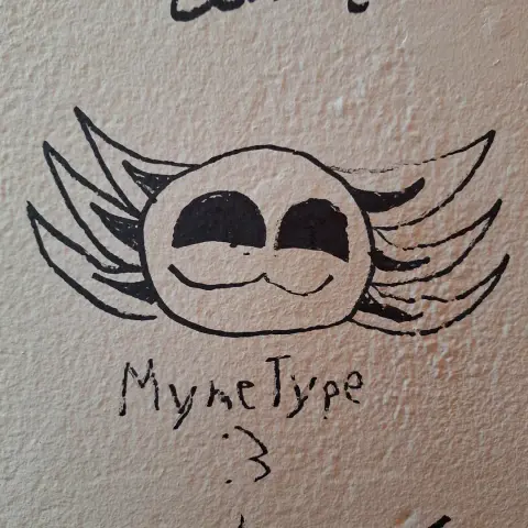 (Crappy) drawing I did on a wall at the con of my fursona's head, with my online name and a :3 face at the bottom