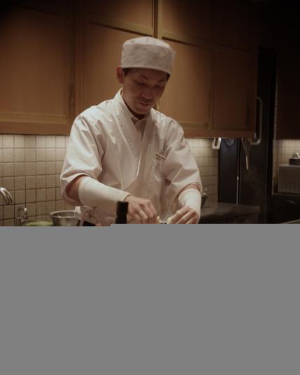 Chef putting tempura into the oil.