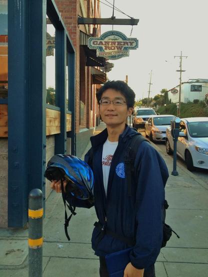 A MIIS student holds his bicycle helmet in his hand as he chatted with us on Cannery Row in Monterey in 2013.