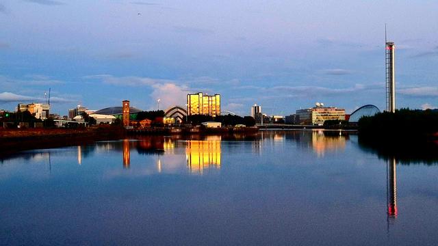 A modern waterfront reflected in the still waters of the Clyde.