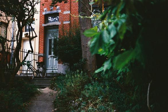 Cute front entrance of a brick house with a bike standing against the wall