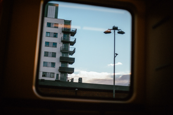 Photograph out of a window on the city train (t-bane). It’s a building near Majorstuen t-bane station.