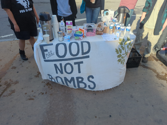 This is a photo of the Wednesday Morning coffee serve. It is a front view of the serving table with the crew behind it.