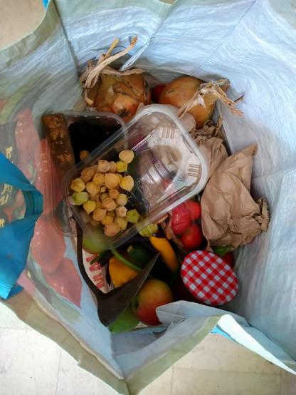 Shopping bag full of Community farm harvest.