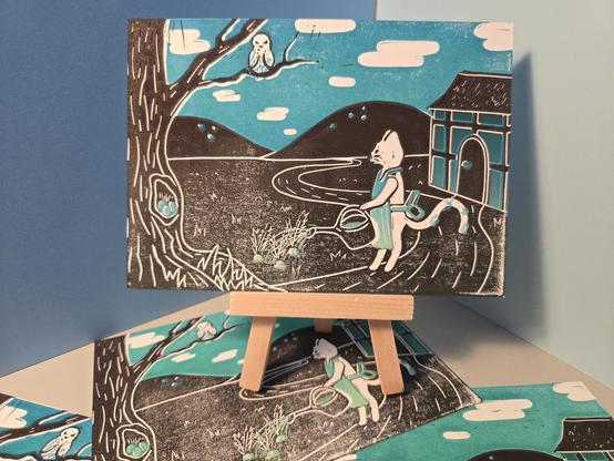 Print on a postcard. The print shows a cat watering some plants; left is a tree with an owl. On the right is a tiny house, and in the background are some hills. The print is in black and blue.