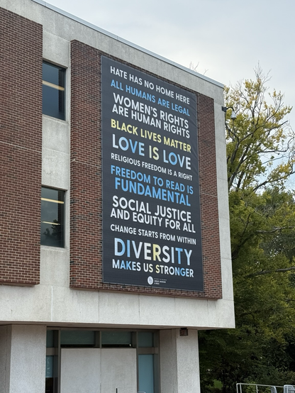 A photograph of a building on the University of Delaware campus proudly expressing pro DEI and pro LGBTQ values.