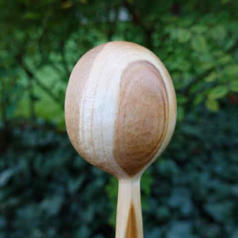 Back of wooden scoop bowl.