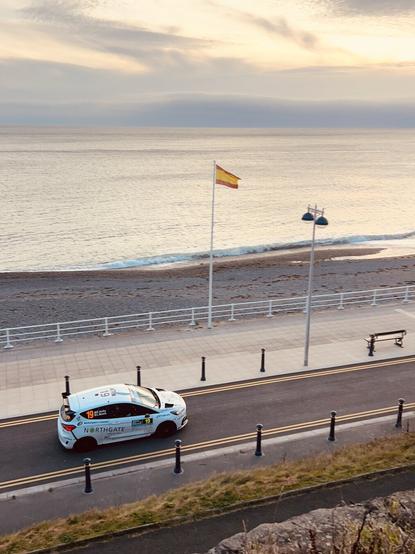 A rally car racing along the Aberystwyth promenade